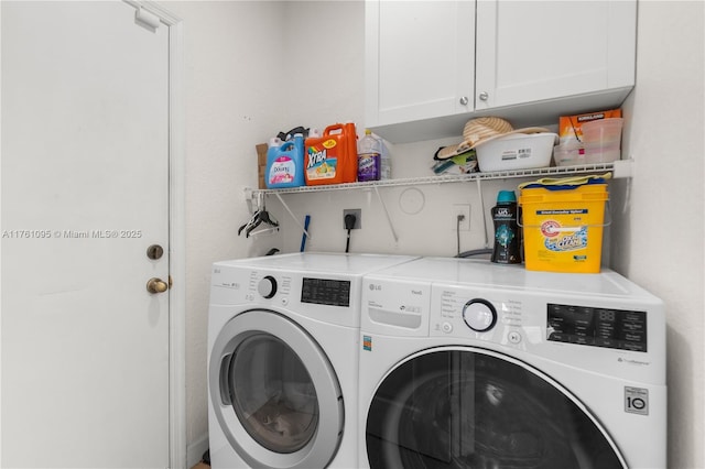 laundry area with cabinet space and separate washer and dryer