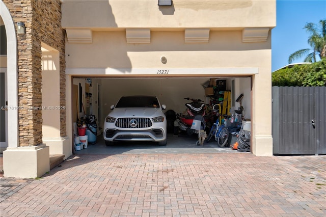 garage with decorative driveway