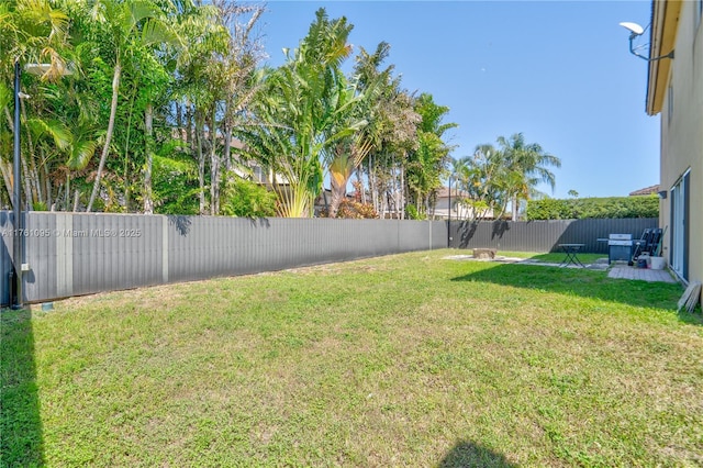 view of yard with a fenced backyard