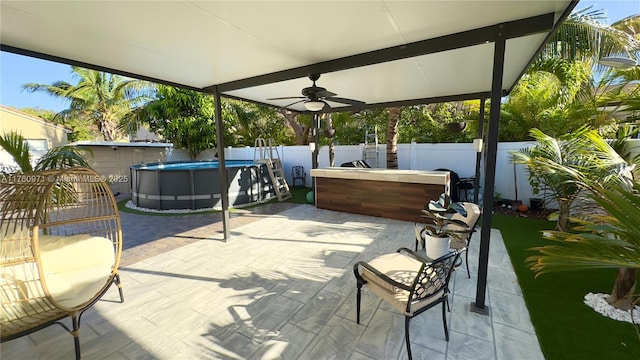 view of patio / terrace featuring a fenced in pool, a fenced backyard, and ceiling fan