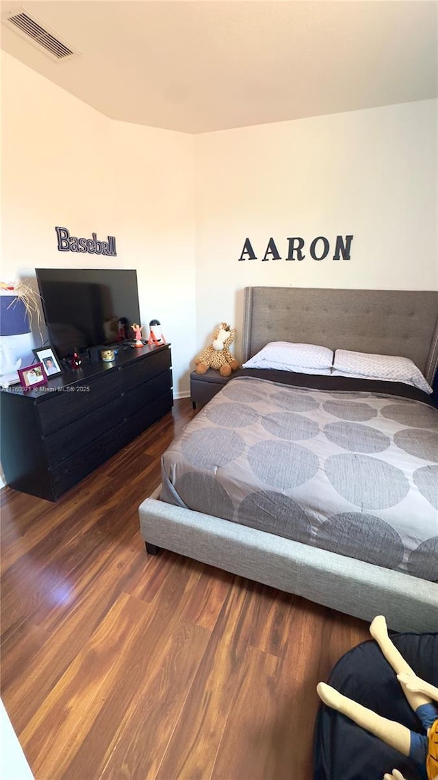 bedroom featuring visible vents and wood finished floors