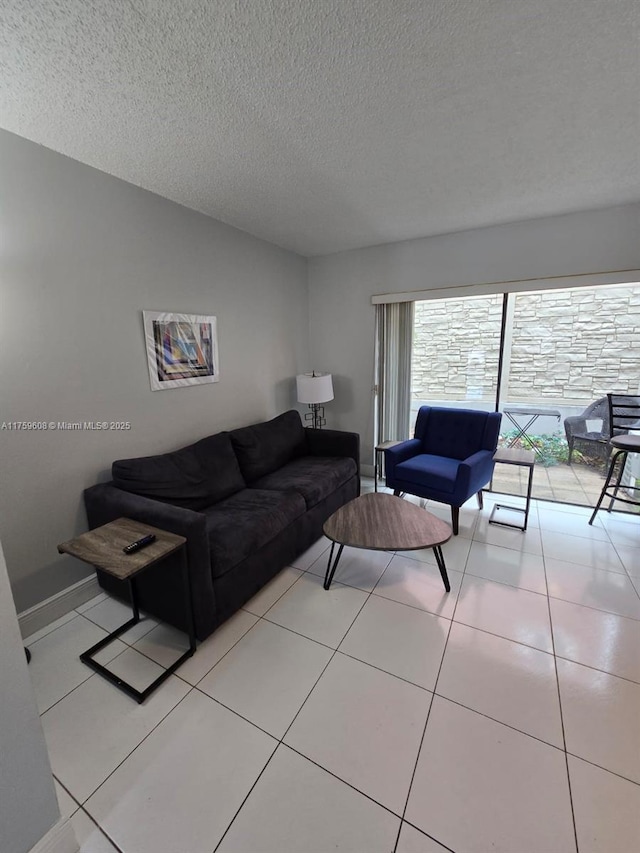 tiled living area featuring a textured ceiling