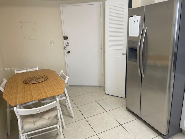 kitchen with light tile patterned floors and stainless steel fridge with ice dispenser