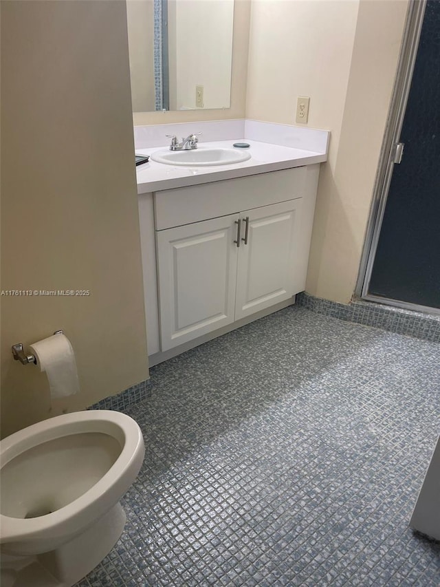 bathroom featuring vanity and toilet