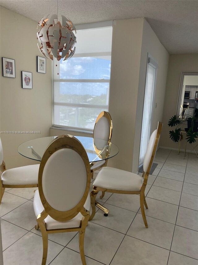 dining room with light tile patterned floors and a textured ceiling