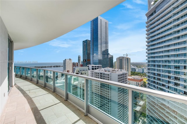 balcony featuring a view of city and a water view