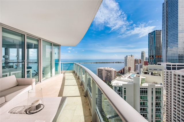 balcony featuring a city view and a water view