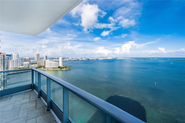 balcony featuring a view of city and a water view