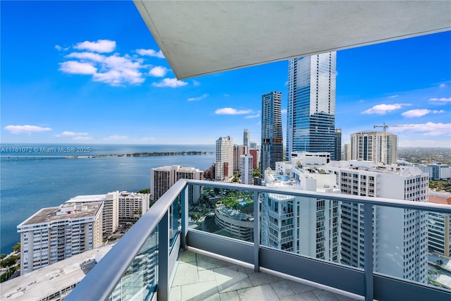 balcony featuring a view of city and a water view