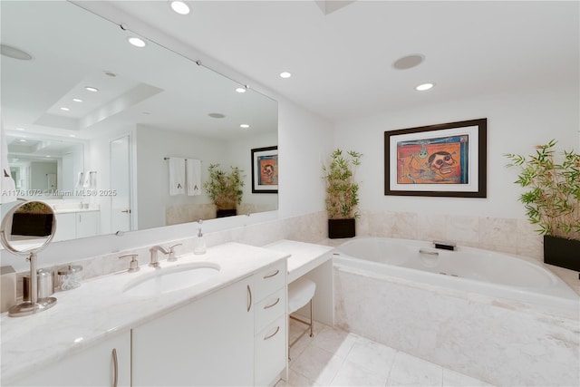 bathroom with vanity, a garden tub, and recessed lighting