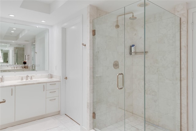 bathroom with recessed lighting, a stall shower, and vanity