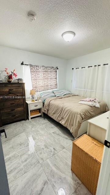 bedroom featuring a textured ceiling