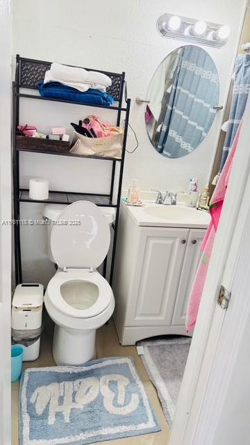 bathroom with toilet and vanity