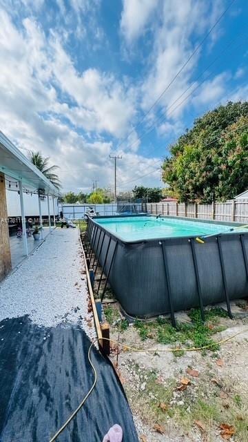 view of swimming pool featuring a fenced in pool and fence