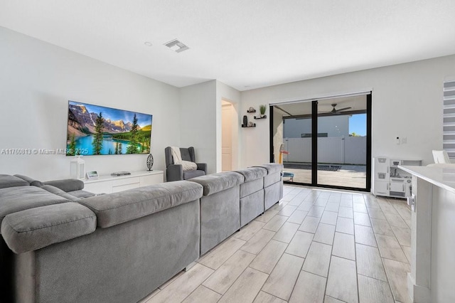 living area with visible vents and wood finish floors