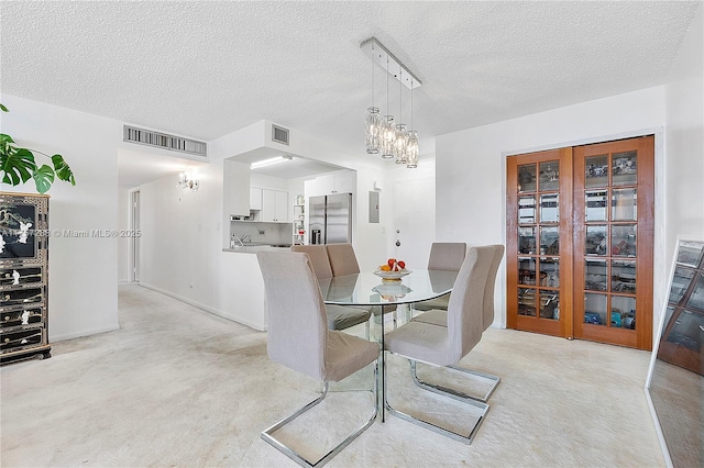 dining room featuring an inviting chandelier, electric panel, visible vents, and a textured ceiling