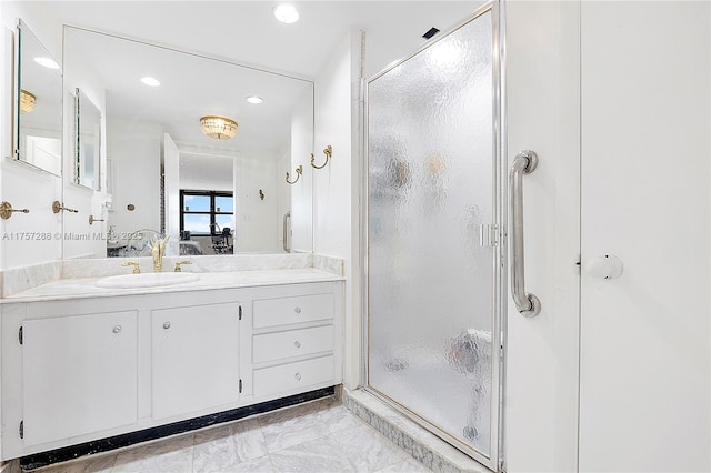 ensuite bathroom with marble finish floor, ensuite bathroom, recessed lighting, a shower stall, and vanity