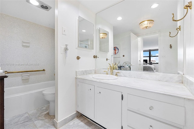 ensuite bathroom with connected bathroom, baseboards, toilet, a tub to relax in, and vanity