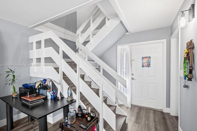 entrance foyer featuring baseboards, wood finished floors, and stairs