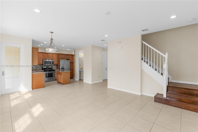 kitchen featuring visible vents, brown cabinets, recessed lighting, appliances with stainless steel finishes, and open floor plan