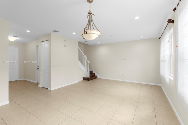 spare room featuring stairway, recessed lighting, baseboards, and visible vents