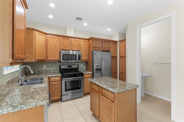 kitchen with a sink, visible vents, appliances with stainless steel finishes, and light tile patterned floors