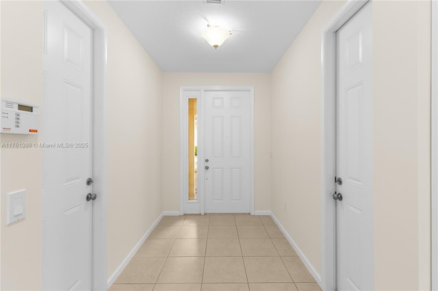 entrance foyer featuring light tile patterned floors and baseboards