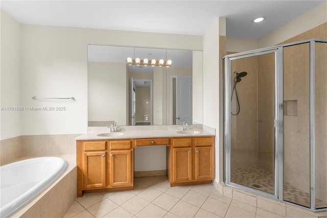 full bath with a sink, a garden tub, a stall shower, and tile patterned flooring