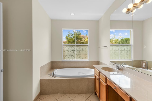 bathroom featuring a bath, tile patterned floors, and vanity