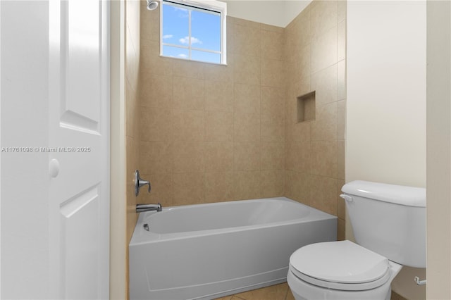 bathroom with tile patterned floors, shower / bathing tub combination, and toilet