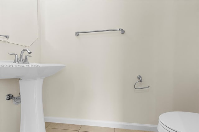 bathroom featuring tile patterned floors, toilet, and baseboards