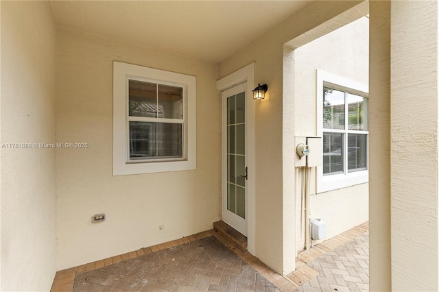 entrance to property with stucco siding