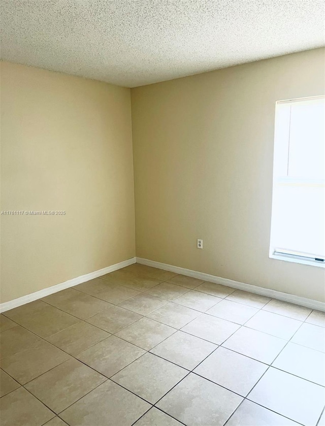 807 Mountbatten Ln, Kissimmee, FL 34758 - spare room featuring light tile patterned floors, baseboards, and a textured ceiling