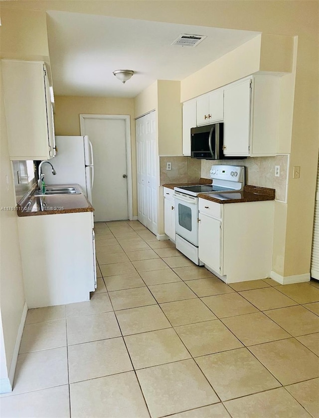 807 Mountbatten Ln, Kissimmee, FL 34758 - kitchen with light tile patterned flooring, visible vents, and white appliances