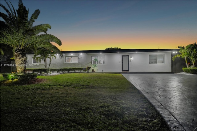 11300 SW 107th Ave, Miami, FL 33176 - view of front of house with stucco siding, a lawn, and driveway