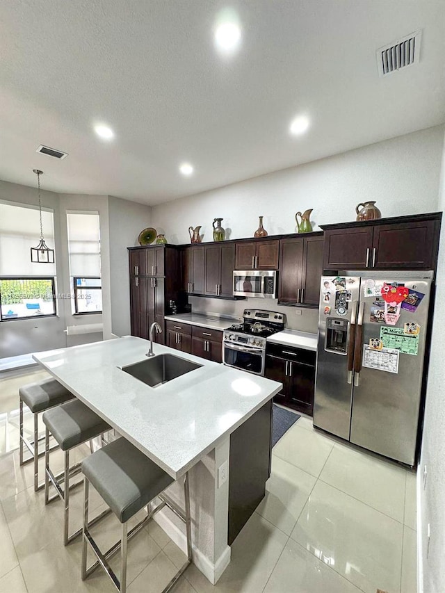 kitchen featuring a sink, light countertops, visible vents, and stainless steel appliances