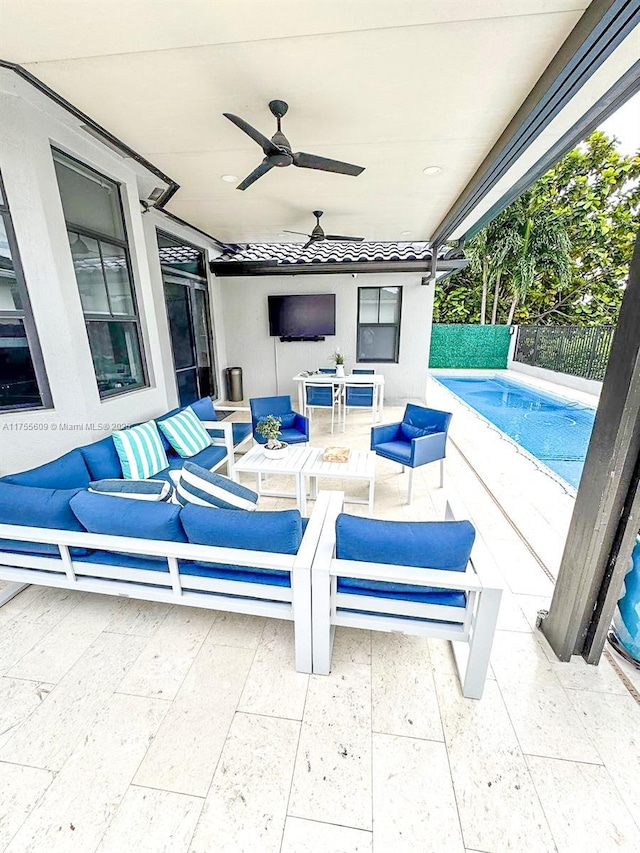 view of patio featuring an outdoor hangout area, a ceiling fan, and fence