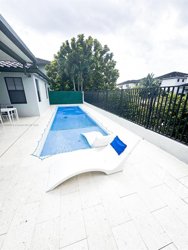 view of pool with a patio area, a fenced in pool, and a fenced backyard