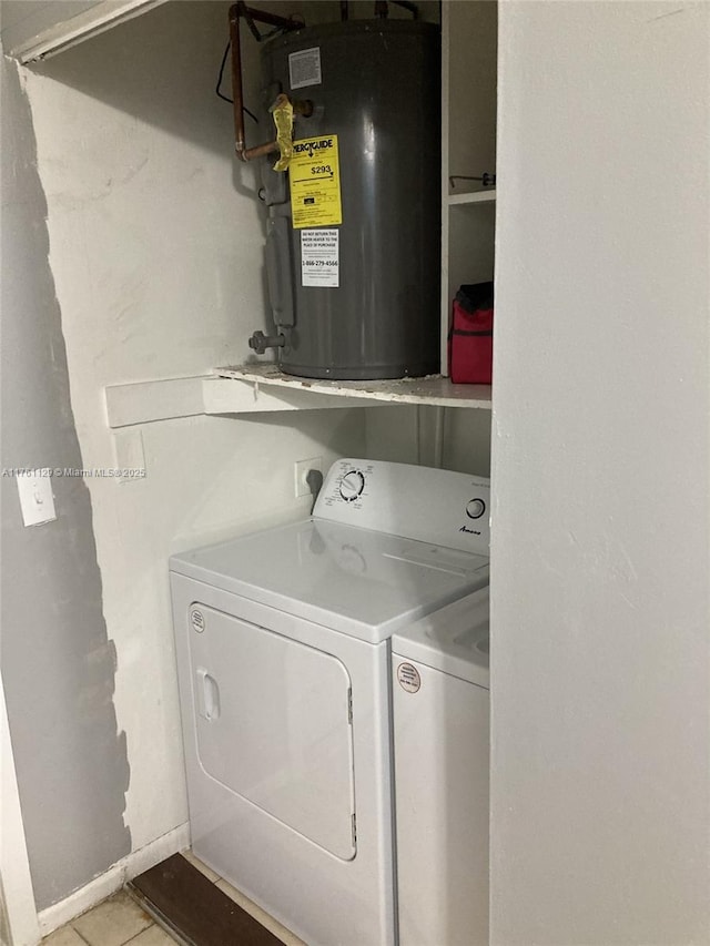 laundry room with tile patterned flooring, water heater, baseboards, and separate washer and dryer