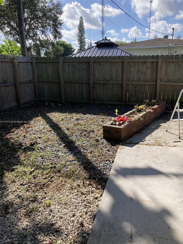 view of yard with a patio and a fenced backyard