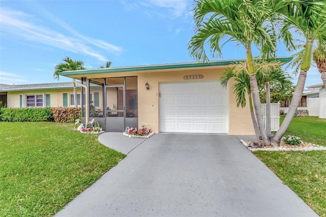 ranch-style home featuring an attached garage, a front lawn, stucco siding, and driveway