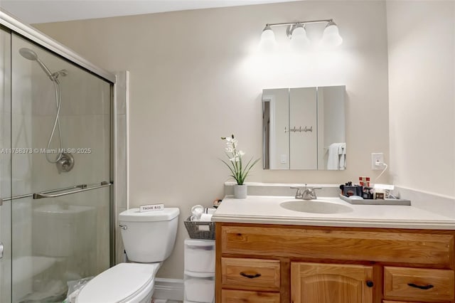 full bath featuring vanity, a shower stall, and toilet