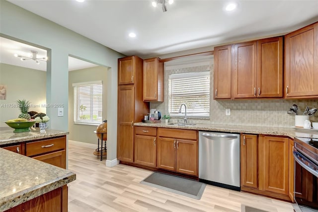 13255 Via Vesta Unit B, Delray Beach, FL 33484 - kitchen with appliances with stainless steel finishes, a sink, light wood-style flooring, brown cabinets, and recessed lighting