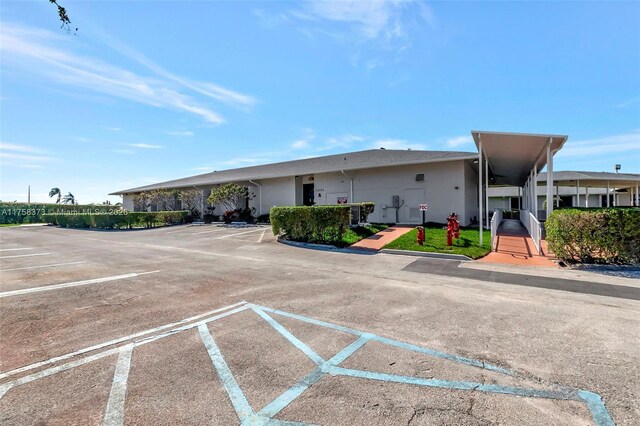 view of property featuring uncovered parking