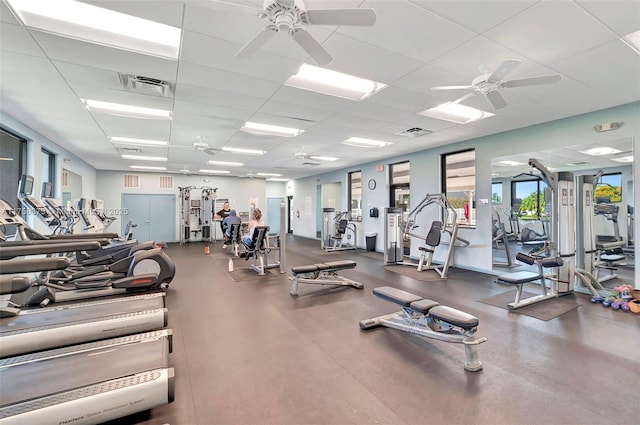 workout area with ceiling fan, a paneled ceiling, and visible vents