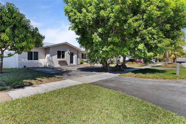 405 SW 73rd Ave, North Lauderdale, FL 33068 - view of front of property with stucco siding, a front lawn, metal roof, and asphalt driveway
