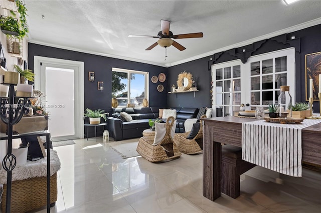 living room featuring ceiling fan, crown molding, french doors, and a textured ceiling