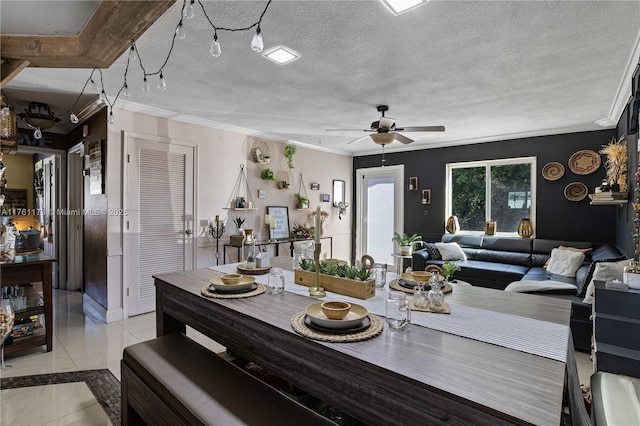 dining area featuring light tile patterned floors, a textured ceiling, crown molding, and a ceiling fan