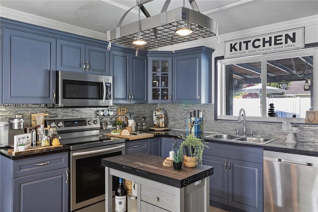 kitchen with blue cabinetry, wooden counters, stainless steel appliances, and a sink