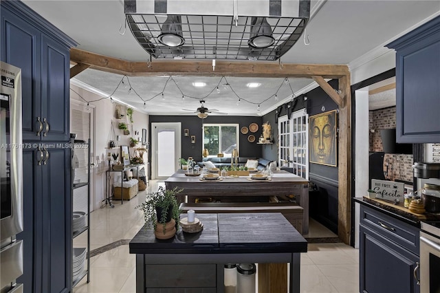405 SW 73rd Ave, North Lauderdale, FL 33068 - kitchen featuring blue cabinetry, crown molding, light tile patterned floors, ceiling fan, and dark countertops